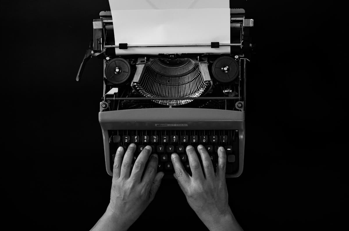 Hands typing on a typewriter